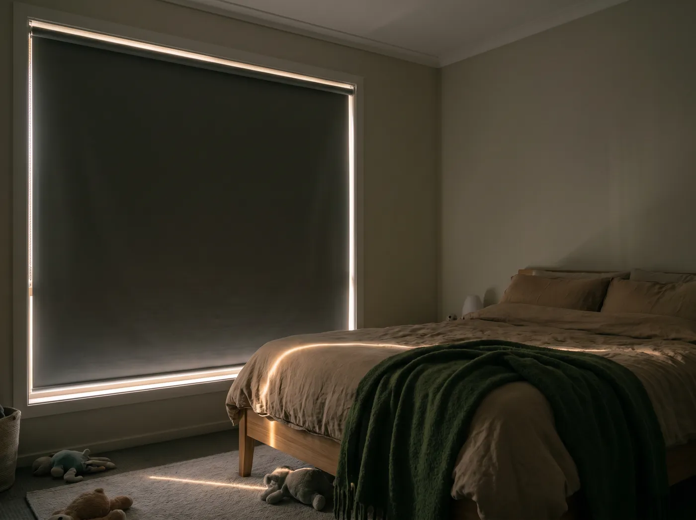 A bedroom made properly dark by a blockout roller blind