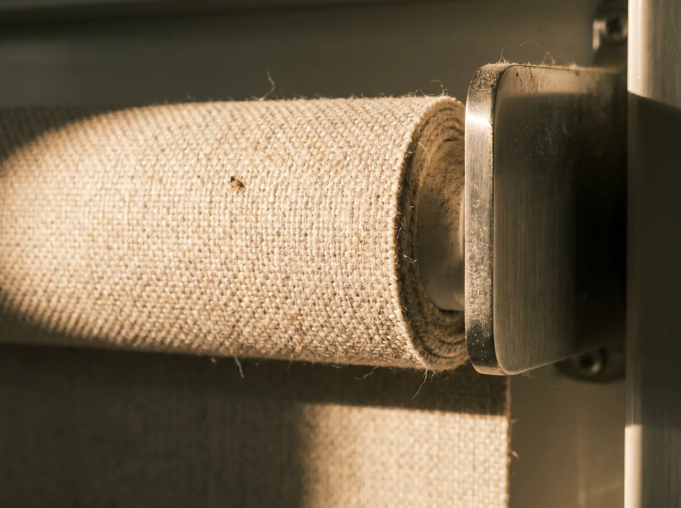 Detail of a made-to-measure roller blind fabric being fitted in a Rutherford home